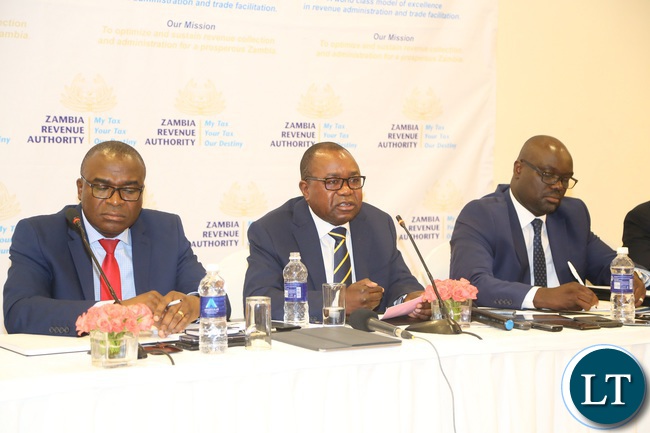 Zambia Revenue Authority (ZRA) Commissioner General Kingsley Chanda flanked by Commissioner Domestic Taxis Moses Shuko (l) and Commissioner Customs Sydney Chibbabbuka speaking to journalists during the press conference