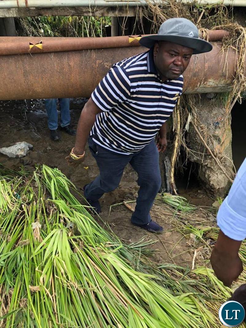 Housing and Infrastructure Development Minister Ronald Chitotela inspecting the damage