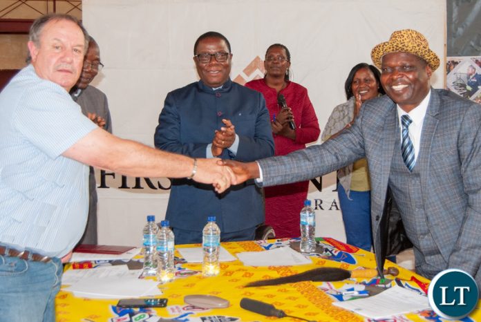 Senior Chief Musele and Kalumbila Minerals Ltd General Manager Morris Rowe shake hands after agreeing to closer co-operation between the mine and the local community Senior Chief Musele and Kalumbila Minerals Ltd General Manager Morris Rowe shake hands after agreeing to closer co-operation between the mine and the local community