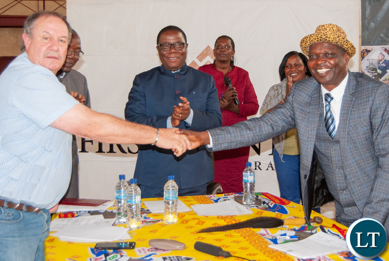 Senior Chief Musele and Kalumbila Minerals Ltd General Manager Morris Rowe shake hands after agreeing to closer co-operation between the mine and the local community