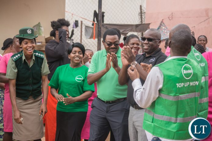 Lusaka Central Female Correctional Facility Deputy Officer in Charge Mary Filinga with the Zamtel team during the hand over of sanitary towels and bath soap for inmates