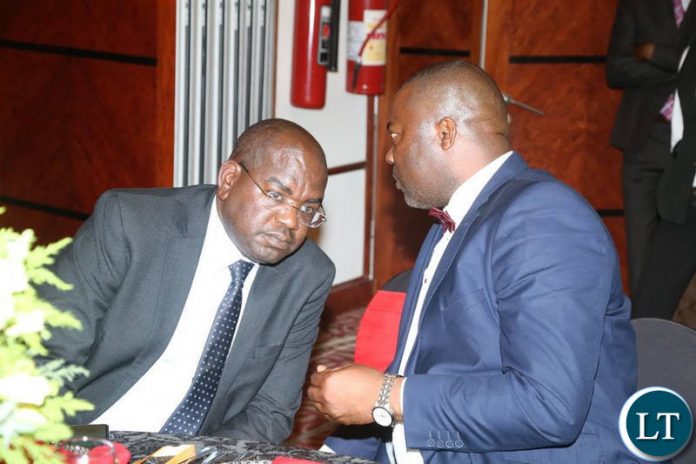 Lusaka Province Minister Bowman Lusambo chats with Health Minister Dr Chitalu Chilufya