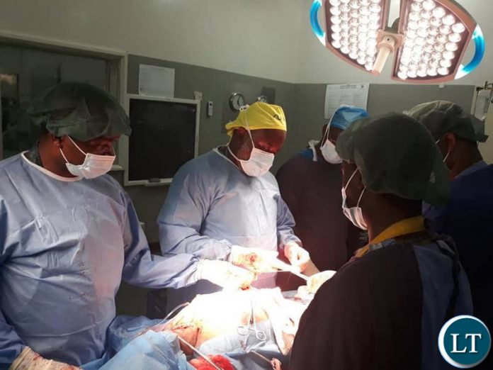 Ndola Teaching Hospital doctors operating on a patient