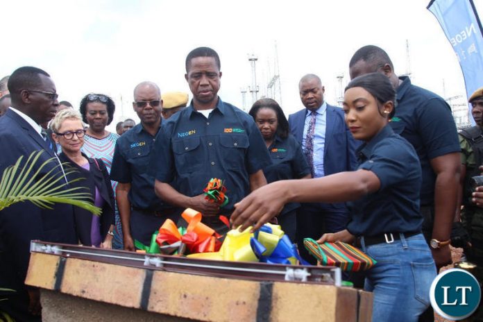 President Edgar Lungu cuts the ribbon to officially commission the solar project