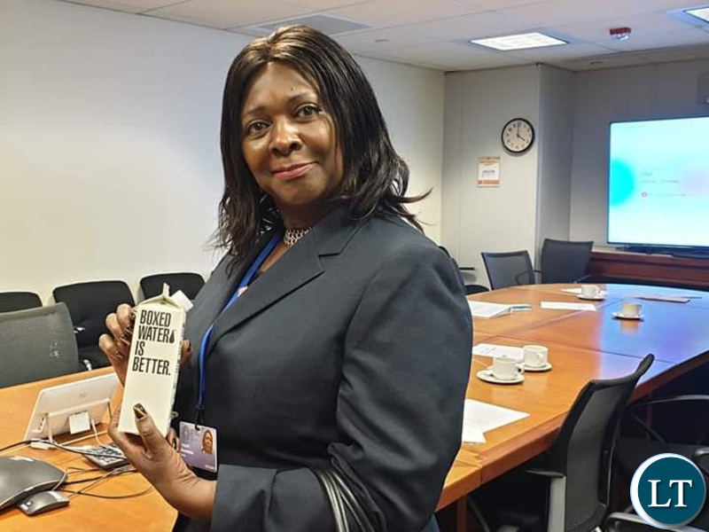 Finance Minister Margaret Mwanakatwe shows off a boxed water after a meeting with the World Bank in Washington D.C