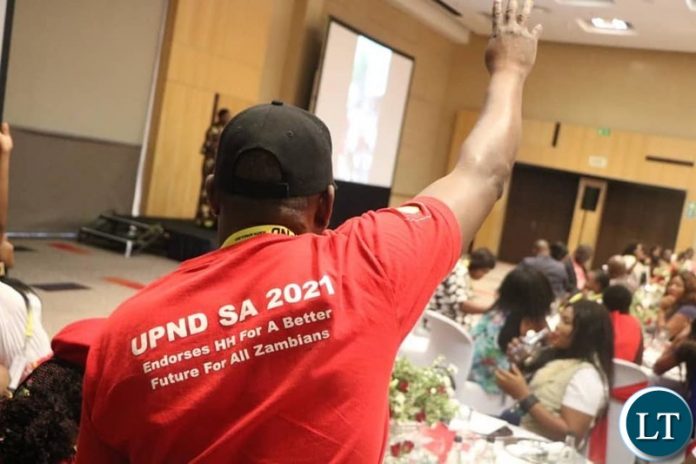 A UPND Cadre raises the PArty symbol to the delegates