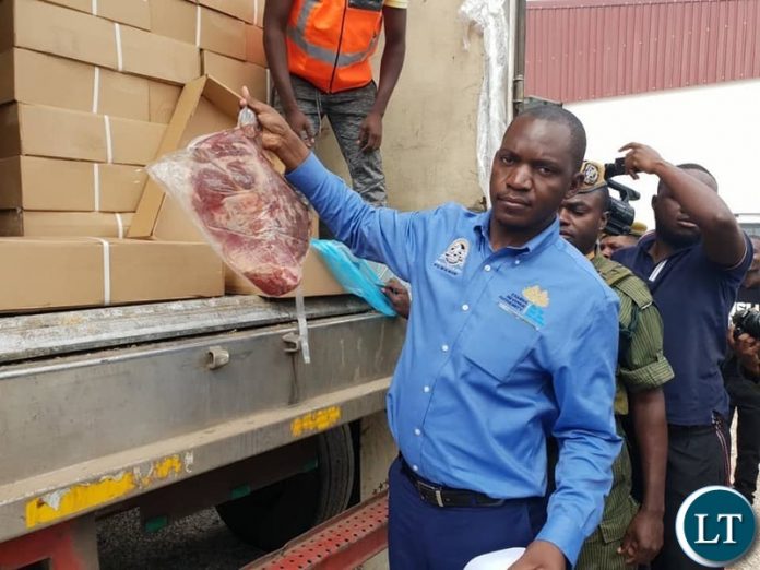 ZRA official displaying the confiscated meat