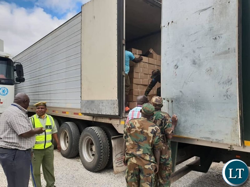 The confiscated boxes of processed meat being offloaded from a truck
