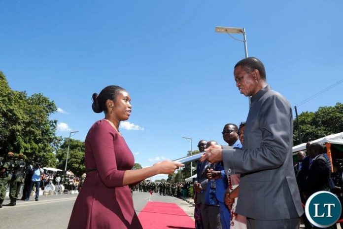 President Edgar Chagwa Lungu (right) presents an award of most hardworking ,innovative and excellent work performance to University of Zambia Social Scientist Dr.Lydia Chabala's daughter Mulenga Chabala (left) at the Freedom Statue in Lusaka on Wedneday,May 1,2019 during the Labour Day Celebrations. Mulenga recieved the award on behalf of her mother. PICTURE BY SALIM HENRY/STATE HOUSE ©2019