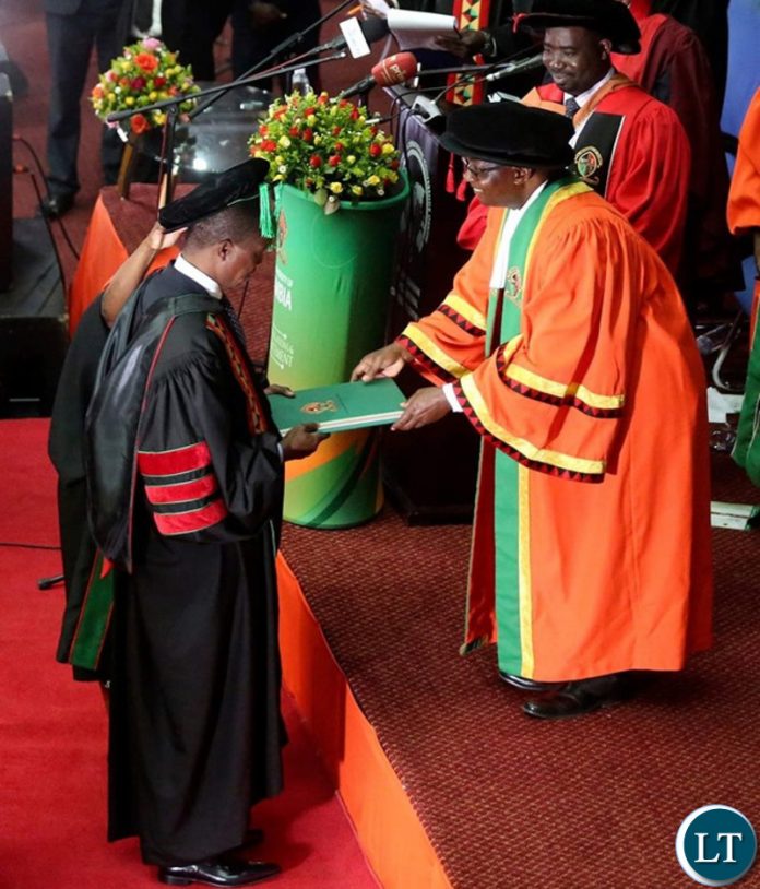 President Edgar Chagwa Lungu (left) receives the Honorary Doctor of Laws Degree Certificate from University of Zambia Chancellor Prof.Luke Mumba (right) at Mulungushi International Conference Centre during the University of Zambia's 48th Special Convocation Ceremony on Saturday,June 29,2019. PICTURE BY SALIM HENRY/STATE HOUSE ©2019 President Edgar Chagwa Lungu (left) receives the Honorary Doctor of Laws Degree Certificate from University of Zambia Chancellor Prof.Luke Mumba (right) at Mulungushi International Conference Centre during the University of Zambia's 48th Special Convocation Ceremony on Saturday,June 29,2019. PICTURE BY SALIM HENRY/STATE HOUSE ©2019
