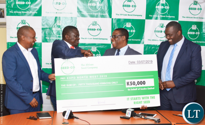 SSED-CO Chairman Chance Kabaghe (second left) shakes hands with North-Western Province Minister Nathaniel Mubukwanu as Expo North Western Coordinator Christopher Bwalya (far right) looks on. – Picture by Andrew-Knox Kaniki/SUMA SYSTEMS. SSED-CO Chairman Chance Kabaghe (second left) shakes hands with North-Western Province Minister Nathaniel Mubukwanu as Expo North Western Coordinator Christopher Bwalya (far right) looks on. – Picture by Andrew-Knox Kaniki/SUMA SYSTEMS.