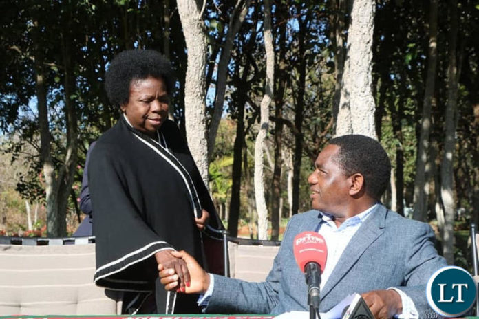 Mr Hichilema shakes hands with Chairperson Mutale Nalumango after the news conference at his residence