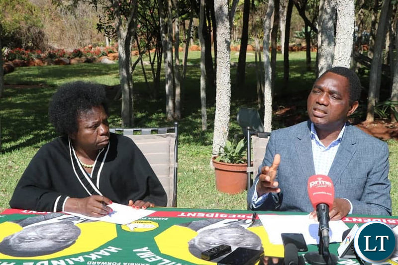 Mr Hichilema speaking at a news conference at his residence as Chairperson Mutale Nalumango looks on