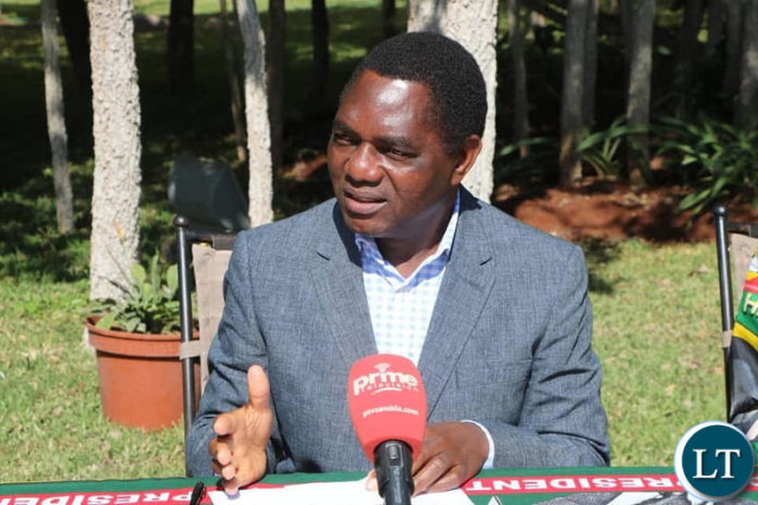 Mr Hichilema speaking at a news conference at his residence.