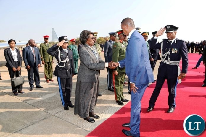 President Edgar Chagwa Lungu greets Vice-President Inonge Wina shortly before departure for Japan where he has gone to attend the 7th Tokyo International Conference on African Development (TICAD), at Zambia Airforce base in Lusaka on Monday, 26th August, 2019, Picture by Eddie Mwanaleza/State House. President Edgar Chagwa Lungu greets Vice-President Inonge Wina shortly before departure for Japan where he has gone to attend the 7th Tokyo International Conference on African Development (TICAD), at Zambia Airforce base in Lusaka on Monday, 26th August, 2019, Picture by Eddie Mwanaleza/State House.