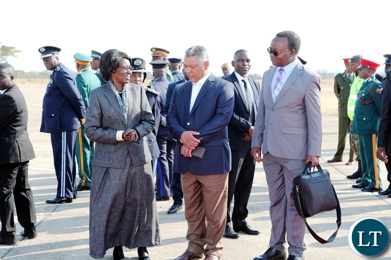 Vice-President Inonge Wina talks to Justice Minister Given Lubinda as Special Assistant to the President for Press and Public Relations Isaac Chipampe looks on, at the Zambia Airfoce base shortly before President Edgar Lungu's departure for Japan on Monday, 26th August, 2019. Picture by Eddie Mwanaleza/State House.