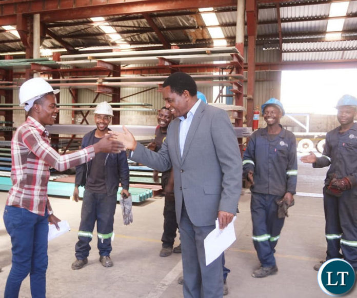 HH interacts with youths working in the Lusaka industrial area