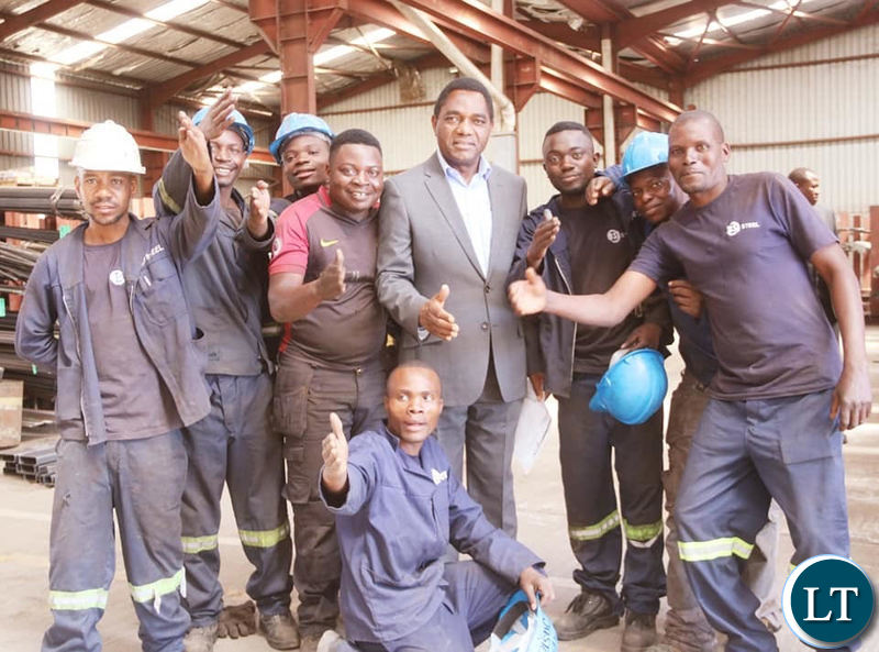 HH interacts with youths working in the Lusaka industrial area