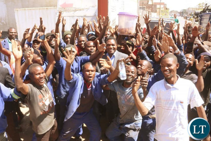 HH interacts with youths working in the Lusaka industrial area