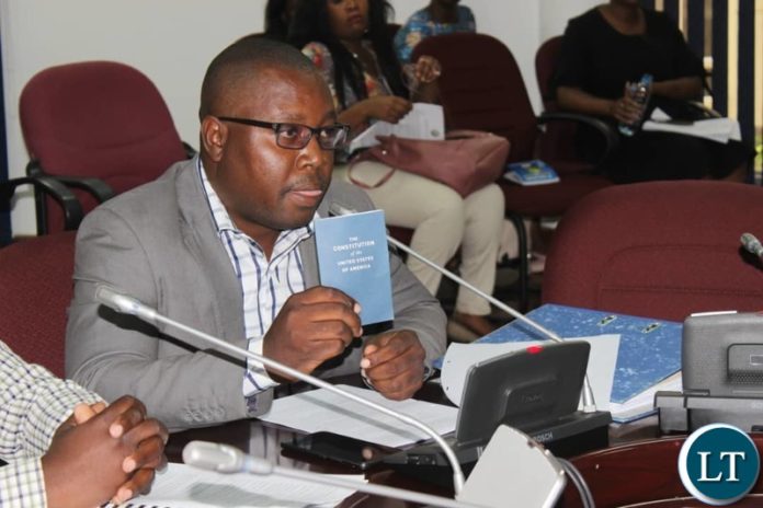 YALI President Andrew Ntewewe shows a copy of the American Constitution to the Committee