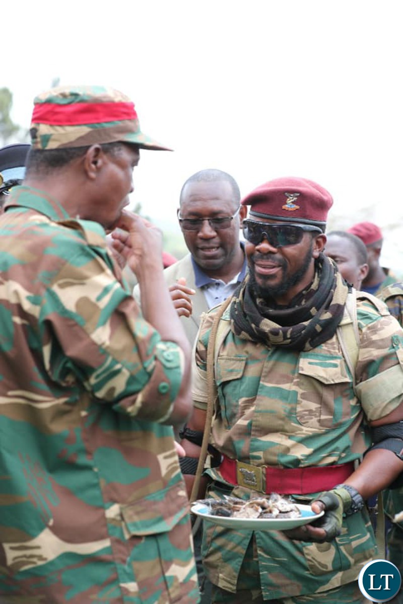 President Edgar Lungu eating a freshly grilled Snake