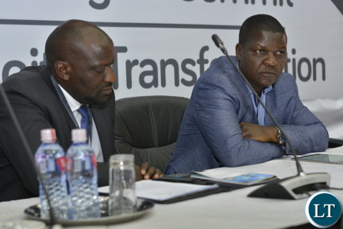 Patrick Mutimushi, Director General ZICTA (reading through his speech before address), with Yese Bwalya, Director Communications - Ministry of Transport and Communication