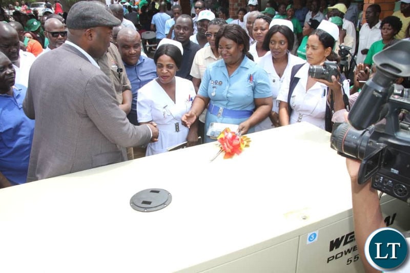 Kabushi Member of Parliament Bowman Lusambo hands over one of the four power gensets to Kabushi clinic on Saturday