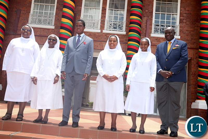 President Lungu and Secretary to the Cabinet Dr Simon Miti poses for a photograph with Catholic Sisters from Cheshire home-Kabulonga, who paid a Courtesy call on the Head of State at State House on Friday, November 8,2019 -Pictures by THOMAS NSAMA