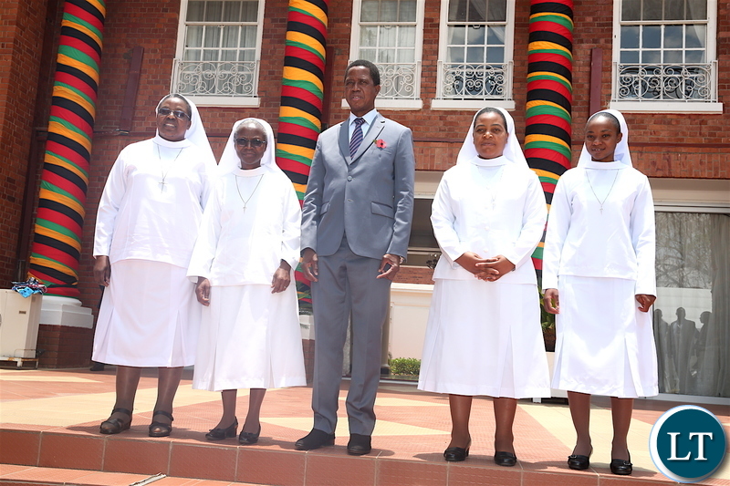 President Lungu and Secretary to the Cabinet Dr Simon Miti poses for a photograph with Catholic Sisters from Cheshire home-Kabulonga, who paid a Courtesy call on the Head of State at State House on Friday, November 8,2019 -Pictures by THOMAS NSAMA