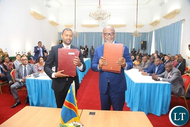 Housing and Infrastructure Development Minister Vincent Mwale with DRC Vice Premier and Minister of Infrastructure Sunzhel Ngoopos at the signing ceremony