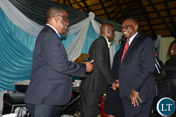 NORTH-Western Province minister Nathaniel Mubukwanu hands over the 2019 Mining Company of the year Award to Kansanshi Mining Plc public relations manager Godfrey Msiska during the North-Western Chamber of Commerce and Industry annual gala and awards ceremony at Kansanshi Hotel in Solwezi on Saturday. - Picture by John Chola. NORTH-Western Province minister Nathaniel Mubukwanu hands over the 2019 Mining Company of the year Award to Kansanshi Mining Plc public relations manager Godfrey Msiska during the North-Western Chamber of Commerce and Industry annual gala and awards ceremony at Kansanshi Hotel in Solwezi on Saturday. - Picture by John Chola.