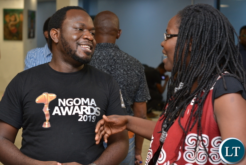 Adrian Chipinde, Director - National Arts Council chatting with Mulenga Mulenga during the exhibition night