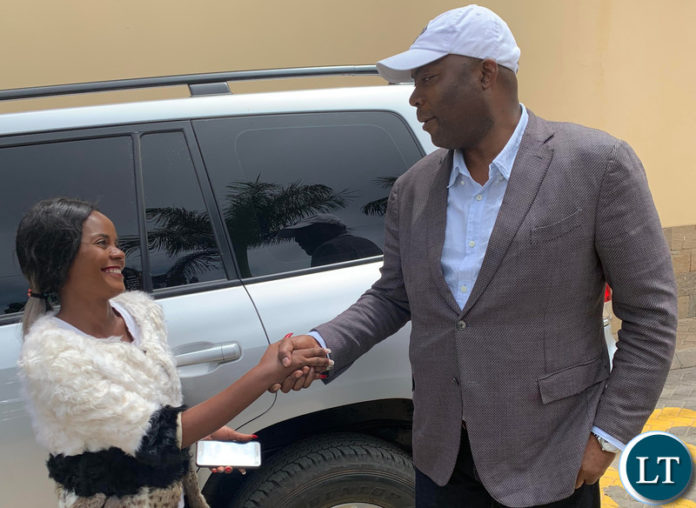 Lusaka Province Minister Bowman Lusambo poses for a photo with Tina Kaluza after She was gifted with a K5,000 Lusaka Province Minister Bowman Lusambo poses for a photo with Tina Kaluza after She was gifted with a K5,000