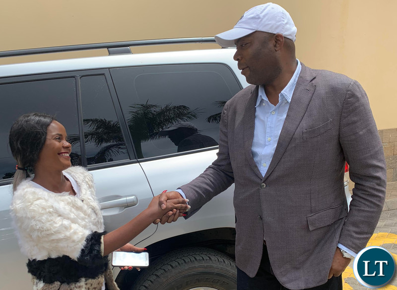 Lusaka Province Minister Bowman Lusambo poses for a photo with Tina Kaluza after She was gifted with a K5,000