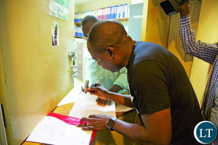 Kalusha Bwalya filing in his nomination papers at Football House