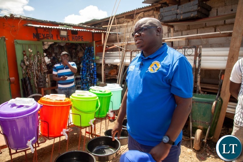 Peoples Alliance for Change President Andyford Banda distributing hand wash basins to Marketeers
