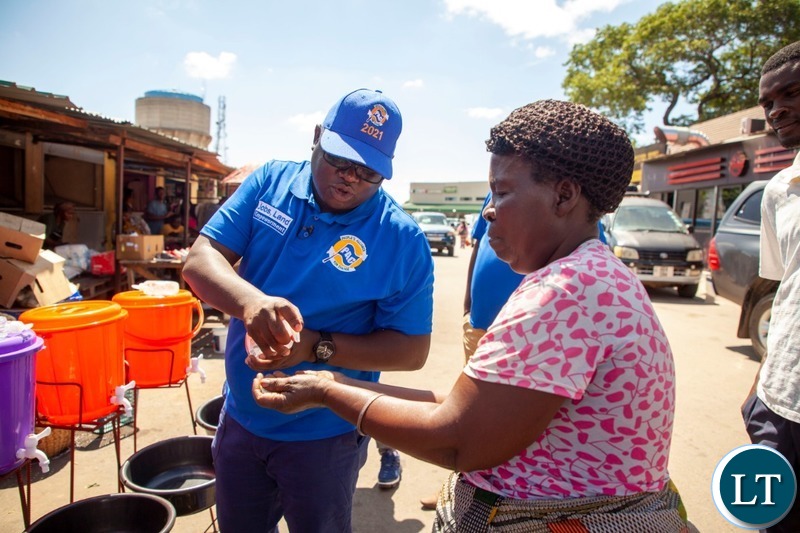 Peoples Alliance for Change President Andyford Banda distributing hand wash basins to Marketeers