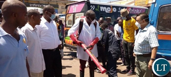 Minister of Local Government Charles Banda leading a team who conducted a sanitising exercise for flash mini buses and the entire millennium bus station Minister of Local Government Charles Banda leading a team who conducted a sanitising exercise for flash mini buses and the entire millennium bus station