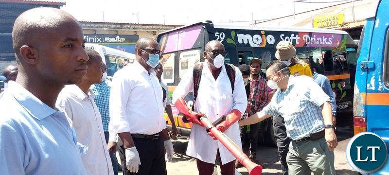 Minister of Local Government Charles Banda leading a team who conducted a sanitising exercise for flash mini buses and the entire millennium bus station