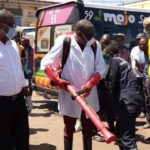 Minister of Local Government Charles Banda  leading a team who conducted a sanitising exercise for flash mini buses and the entire millennium bus station