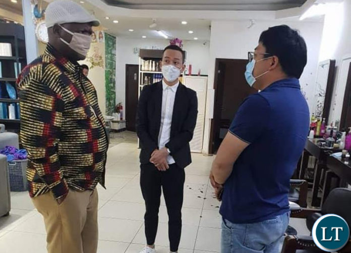 Miles Sampa talking to the owners Angels Barbershop at Arcades Shopping Mall