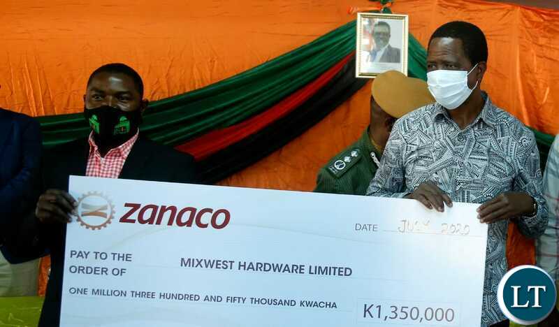 President Edgar Chagwa Lungu hands over a Grant Cheque to Mukelebai Mulonda of Mixwest Hardware Limited in Lukulu district, Western Province