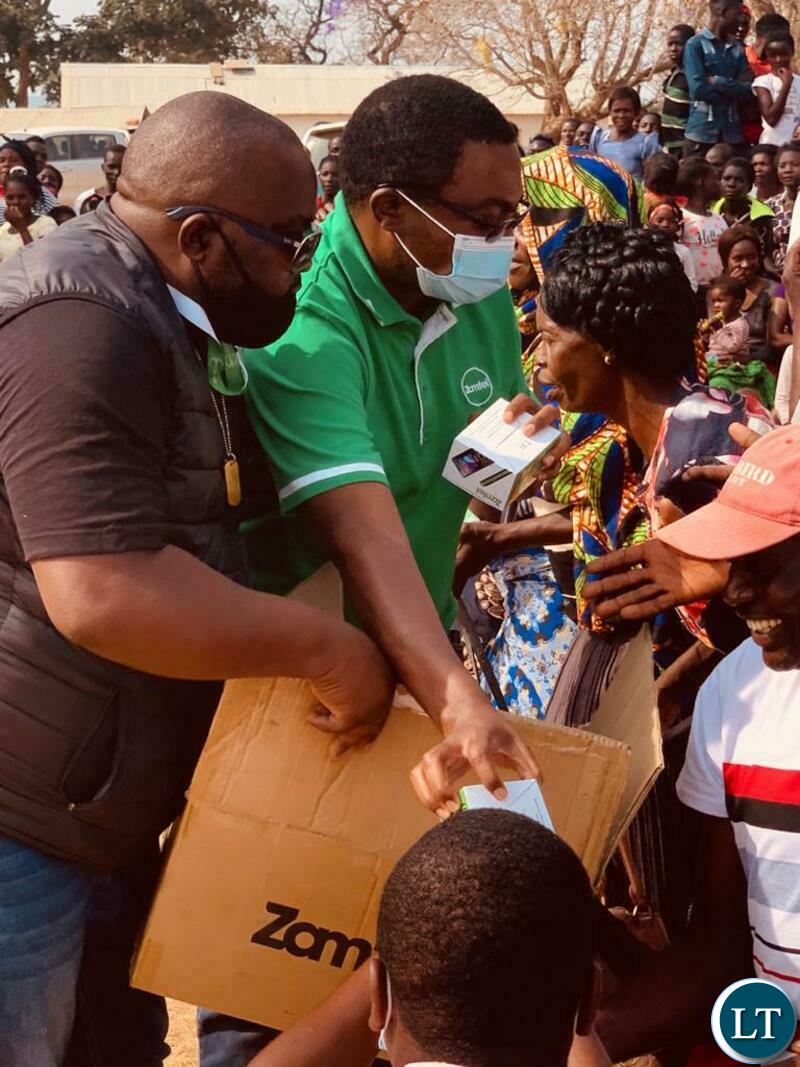Zamtel staff handing over mobile handsets to villagers at Shibwalya Kapila. The phones were procured by area Member of Parliament Mutotye Kafwaya.