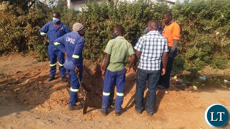 Lusaka Water & Sewerage Company workers in Mtendere B trying to establish source of water contamination.
