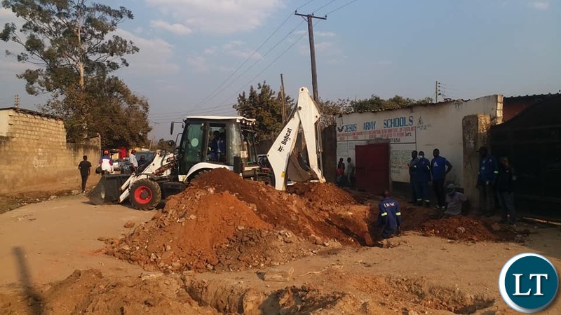Lusaka Water & Sewerage Company workers  in Mtendere B trying to establish source of water contamination.