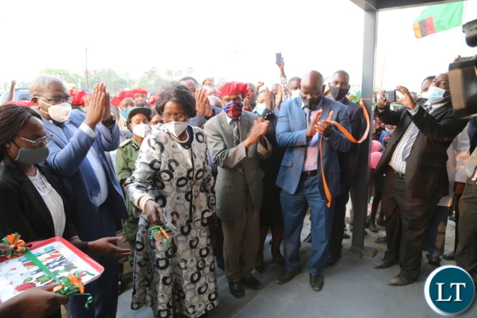 Vice President Inonge Wina, Ngambela Mukela Manyando and Minister of Health Chitalu Chilufya cutting the ribbon to officially commissioning the Lealui Mini hospital in Lealui western province