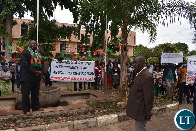 Southern Province Minister Edify Hamukale(in a Zambian flag scarf) listening to former Intercontinental Hotel, Zambezi Sawmills, Rainbow Lodge and Eagles Travel employees presented petitions at his office in Livingstone,calling on President Edgar Lungu to constitute an inquiry in the Privatisation process. Picture by KELVIN MUDENDA
