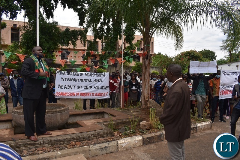 Southern Province Minister Edify Hamukale(in a Zambian flag scarf) listening to former Intercontinental Hotel, Zambezi Sawmills, Rainbow Lodge and Eagles Travel employees presented petitions at his office in Livingstone,calling on President Edgar Lungu to constitute an inquiry in the Privatisation process. Picture by KELVIN MUDENDA
