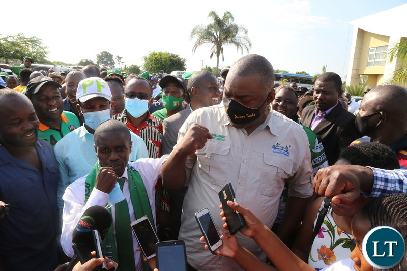 Patriotic Front Copperbelt Provincial Chairman MCC Nathan Chanda with Copperbelt Chairman Mobilization Bowman Lusambo embraces one another after a meeting with PF Secretary General Davis Mwila at Moba Hotel in Kitwe