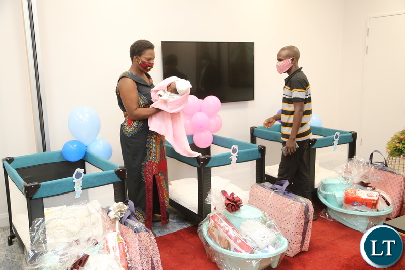 Mother of quadrato (4) babies Elizabeth Phiri Bwalya and Father Daniel Bwalya admiring presents given to there babies Edgar, Jeremiah, Jessy and the only female Esther